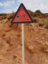 A sign cautions against radioactive residues of uranium mining.